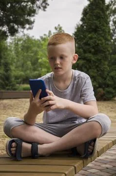 The child communicates on the phone Stock Photos