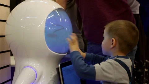 The child communicates with the robot. Modern robotic technologies. Artificial Video stock 86283369