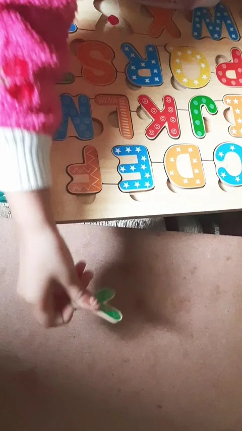 Child Completing Alphabet Puzzle by Matching Letter Y Stock Footage 344111020