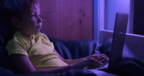 Child with computer at home, 8 years.  Boy typing text message on keyboard. L Stock Footage 127648375