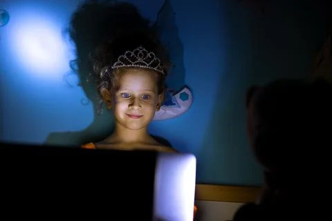 Child On A Computer Screen At Night In Her Bad Stock Photos
