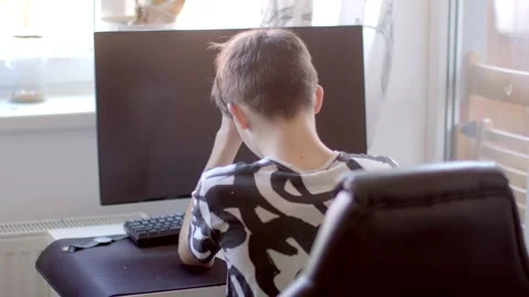 A child at a computer shows frustration with homework and technology Stock Footage 311206128