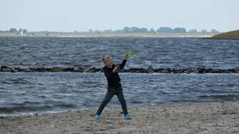 Child controls the kite on the beach Vidéo 253701820