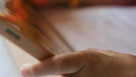 Child controls mobile game with one finger on touchscreen tablet during digital Stock Footage 337663751
