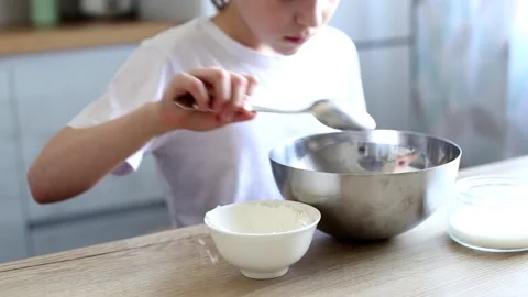 Child cooking at the kitchen. boy stirring dough for a cake Stock-Footage 165547324