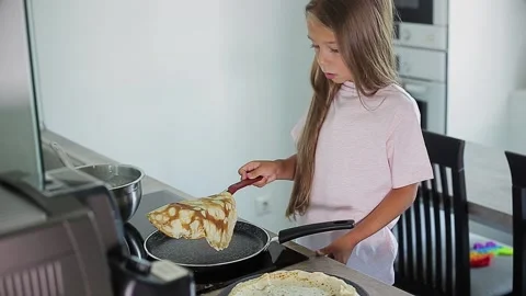 Child cooking pancakes in kitchen Stock Footage 166166356