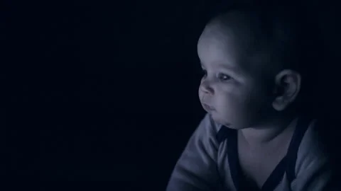 The child covers his face from the light in the dark Stock-Footage 85532145