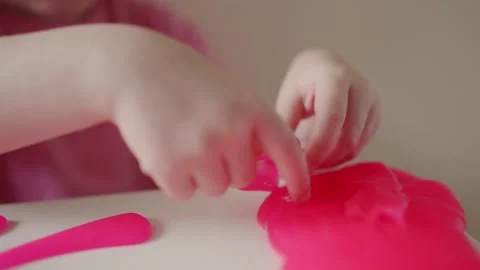 Child crafts with pink modeling clay in simple activity at home Stock Footage 341508095