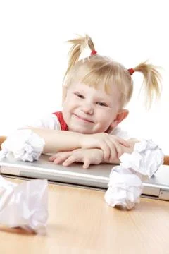 Child with crampled sheets of paper at the table Stock Photos
