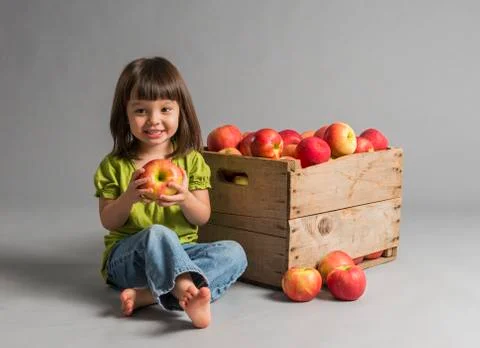 Child with crate of apples 스톡 사진