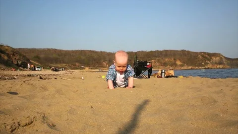 The child crawls along the sand. Stock Footage 89783057