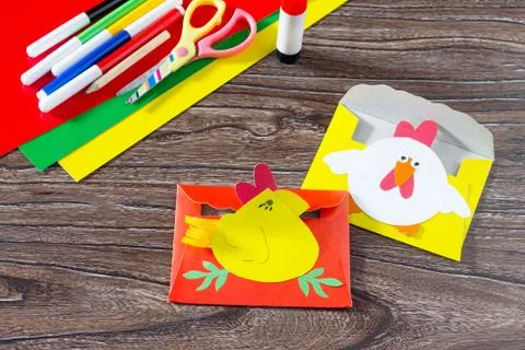The child create an Easter postcard rooster and chicken, top view. Stock Photos