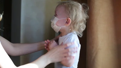 Child cries and does not want to wear a protective mask during the epidemic Stock Footage 126918100