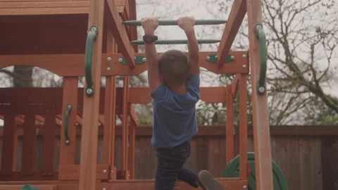 Child Crossing Monkey Bars From Behind Stock Footage 208766684