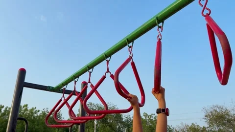 Child Crossing Monkey Bars On Outdoor Adventure Playground In Evening Light Stock Footage 340956766