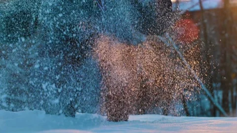 The child crouches down and throws snow in the air. Stock Footage 221764827
