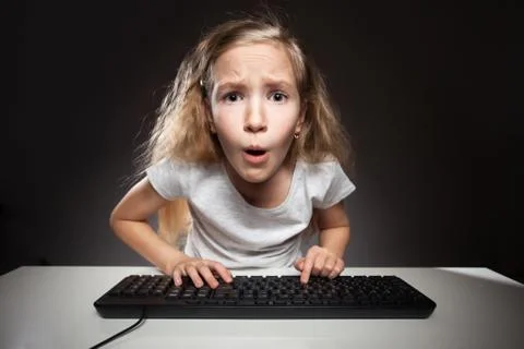 Child curiously looking into the computer Stock Photos