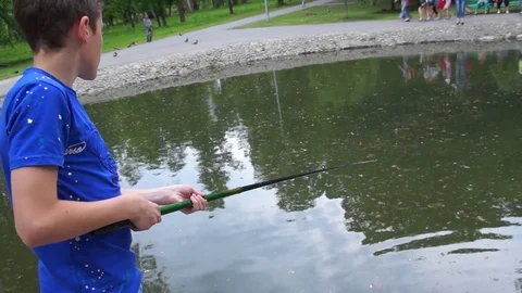 The child cuts and sniffs fish. Stock Footage 76860999