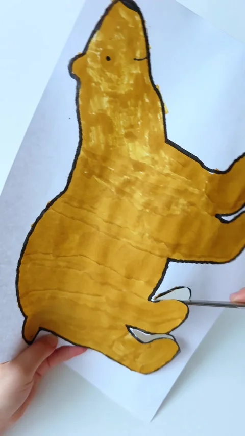 The child cuts paper with scissors at the table. Children's creativity. Video stock 309847159