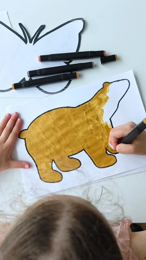 The child cuts paper with scissors at the table. Children creativity. Video stock 309880857