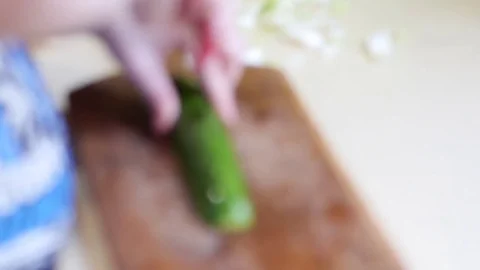 Child cutting cucumber - blurred background Stock Footage 73120021