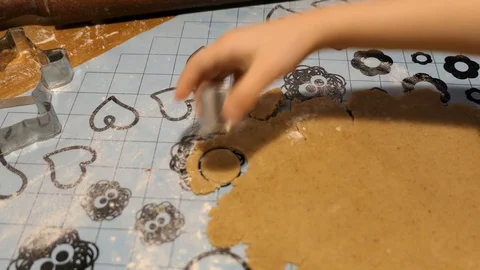 Child cutting gingerbread from the dough Stock Footage 128581863