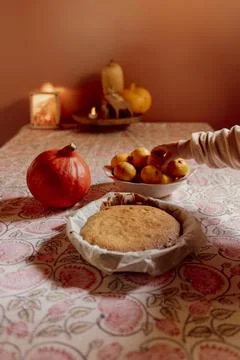 Child cutting homemade cake on patterned tablecloth Stock Photos
