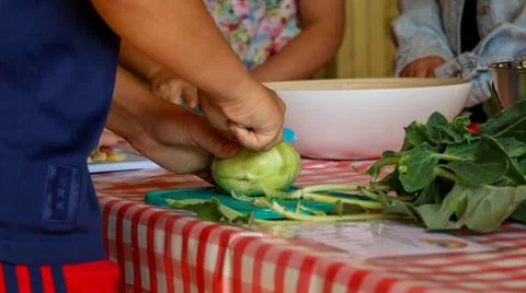 Child cutting vegetable Stock Photos