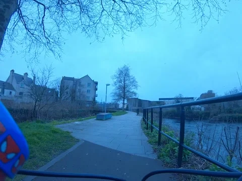 Child cycling by river Stock Footage 232960071