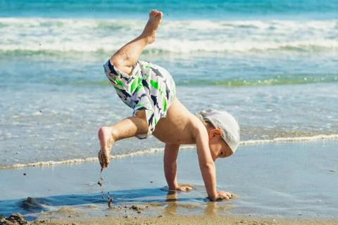 Child dancing on the beach Stock Photos