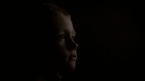 A child in the dark is watching TV Stock Footage 80591442
