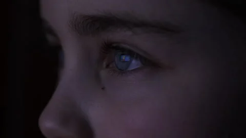 Child in Dark is Watching TV Playing Video Game. Close-up Face of Little Gi.. Stock Footage 315692923