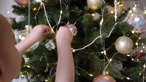 Child decorating the Christmas tree The child is decorating the Christmas t.. Stock Footage 228680167