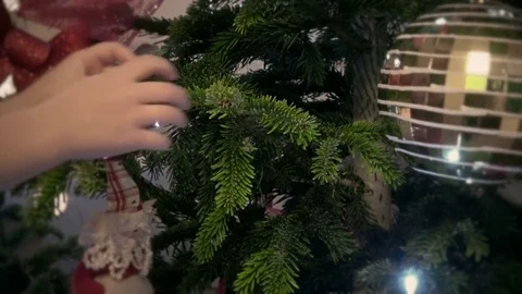 Child decorating a chrtistmas tree Stock Footage 70874203
