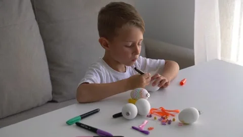 Child Decorating Easter Eggs with Markers at Home 스톡 동영상 330466484
