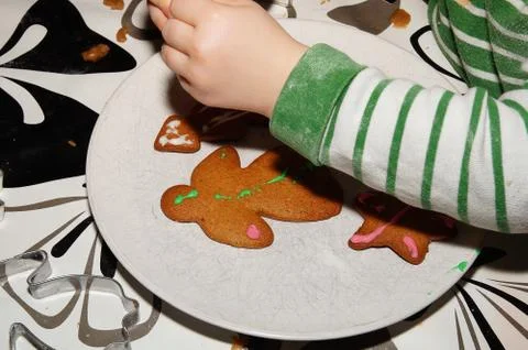 Child decorating gingerbread Stock Photos