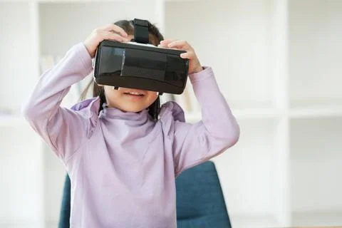 Child Delighted by Virtual Reality Experience An elementary aged girl uses... 写真素材