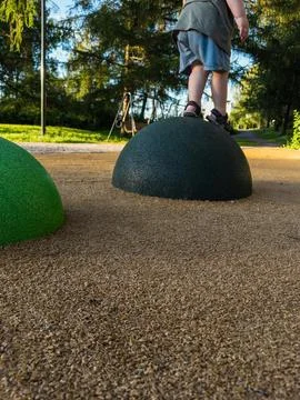 Child developing coordination on playground balancing elements. Stock Photos