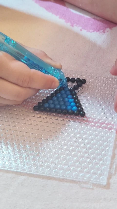 Child Developing Fine Motor Skills With Beads Stockbeeldmateriaal 333094291