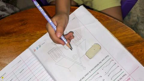 Child Developing Fine Motor Skills Through Pencil Tracing Exercise Fotos Stock