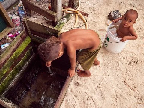 Child in developing world fresh water well supply, Pacific Islands Stock Photos