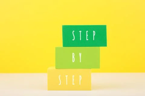 Child development concept. Step by step text written on multicolored toy blocks Stock Photos