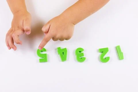 Child development. Counting training. The child points to the numbers. selective Stock Photos