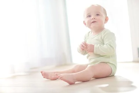Child development, eating and teething biscuit with toddler on floor in liv.. Stock Photos