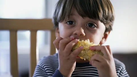 Child devouring corn. One small boy close up face eating healthy snack. Por.. Stock Footage 236952776