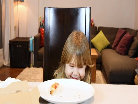 Child devouring end of pizza at home Stock Footage 71395989