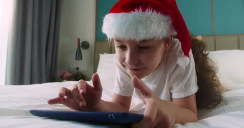 Child with digital tablet. Kid dream online video games at Christmas. Daughter Stock Footage 219032276