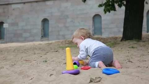 A child digs in the sand Stock Footage 136239434