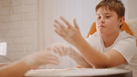 Child diligently practicing pumpkin pie dough preparation at home. Young boy Stock Footage 346395571