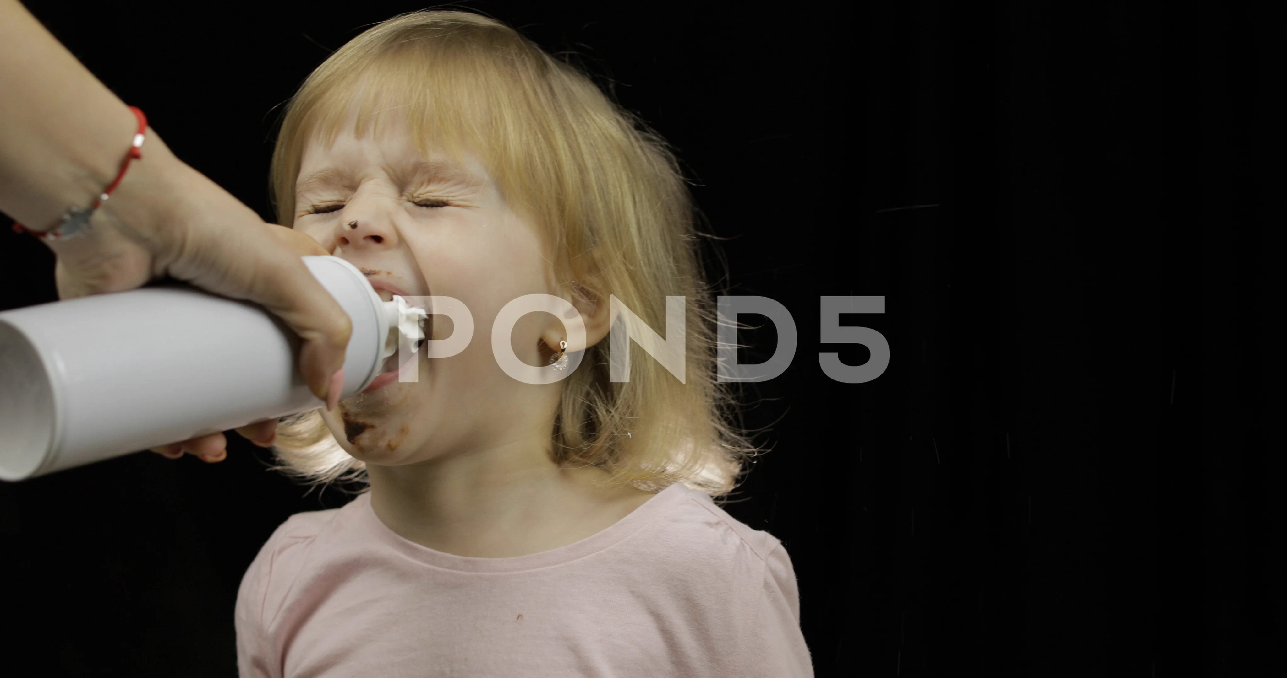 Man playing child's game with whipped cream on face Stock Photo